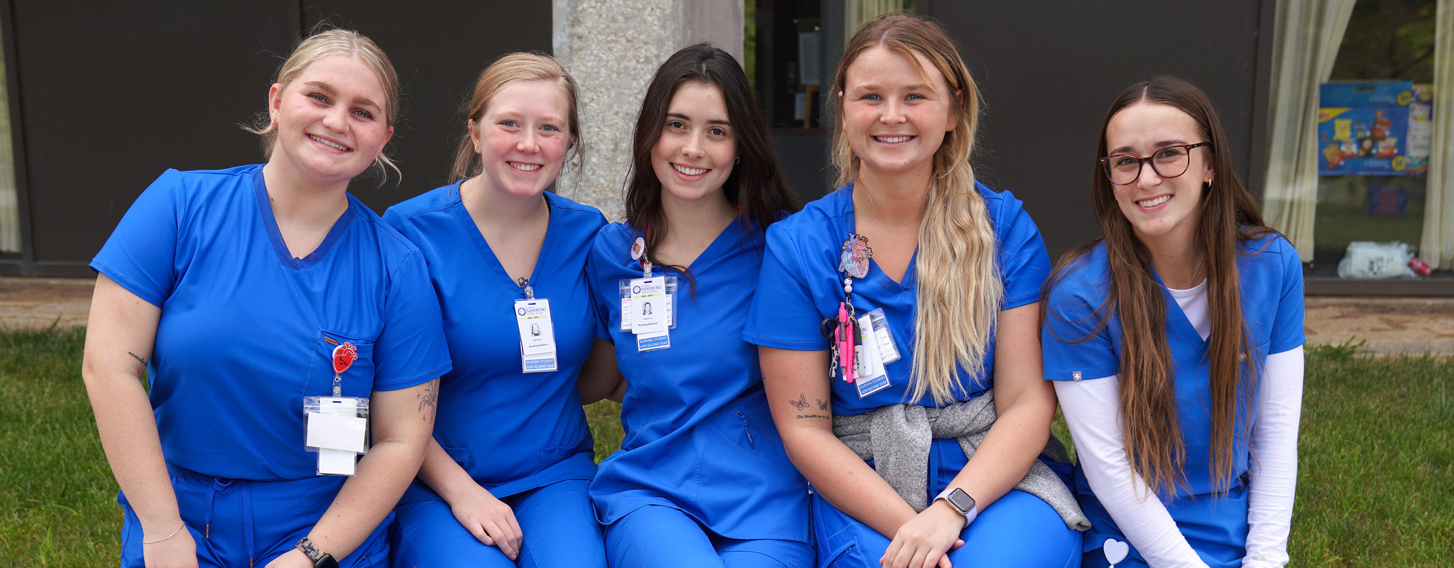 Group of nursing students sitting on bench.