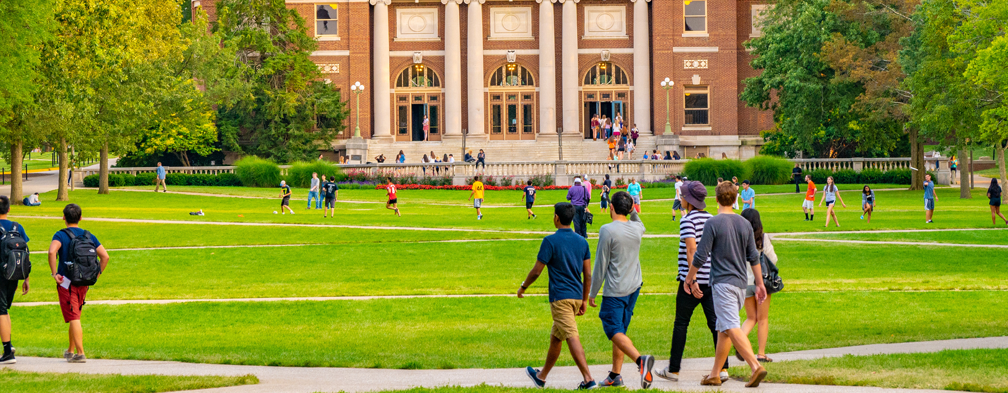 a campus quad with student walking to class.