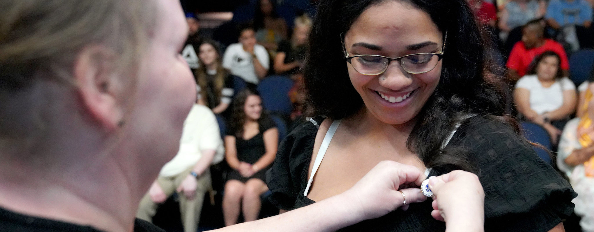 student receiving her medical assistant pin.