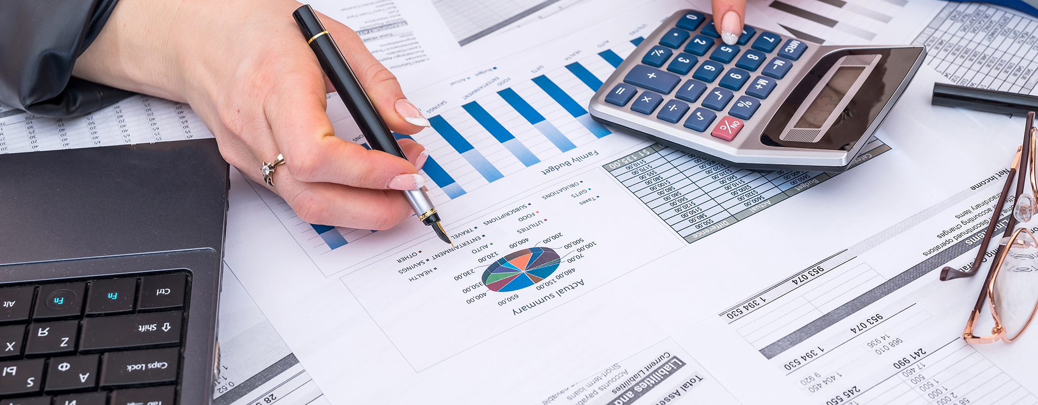 a calculation sitting on a bunch of papers with budget info on them.