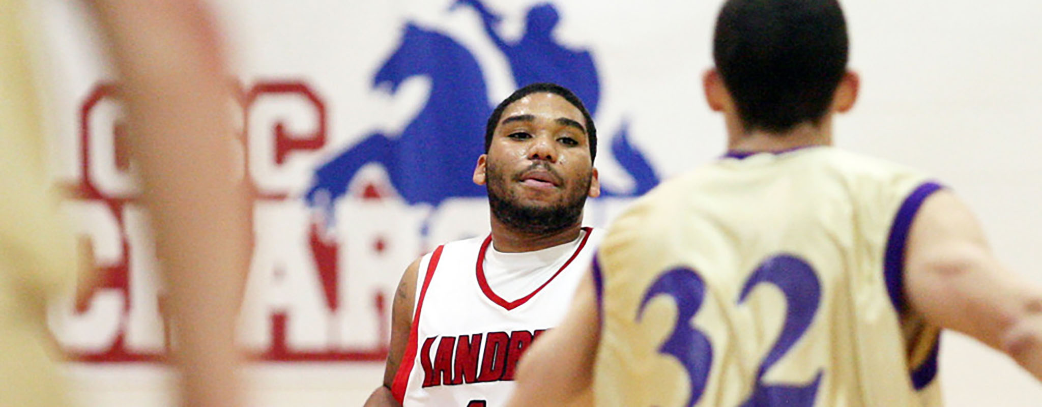 Sandburg basketball player dribbling a basketball in a game against Knox college.