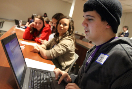 students sitting in a lecture hall.