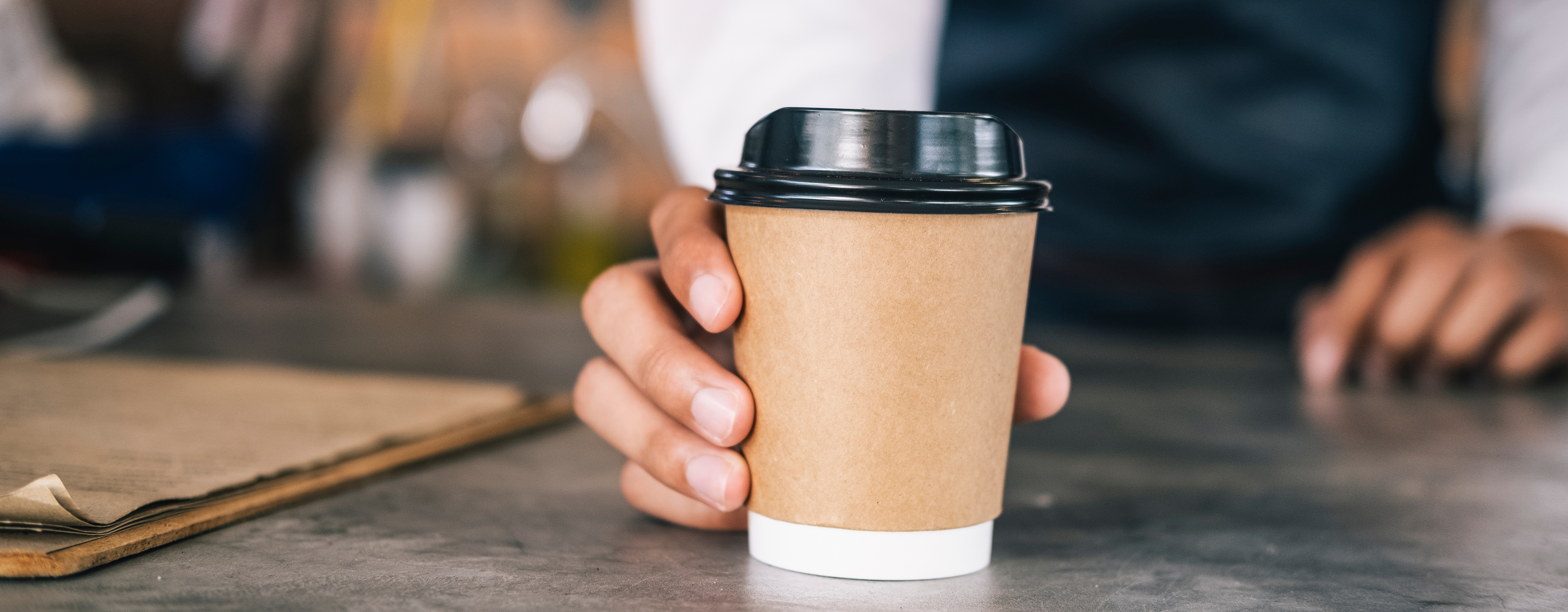 A cup with lib on it on coffee shop counter.