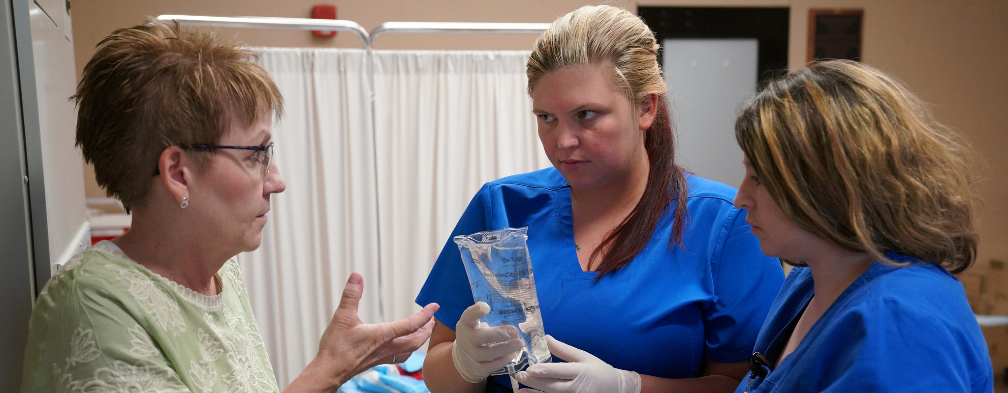 nursing instuctor talking to student about an IV.