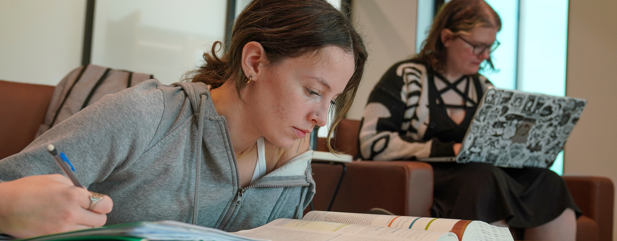 student doing homework in study area.