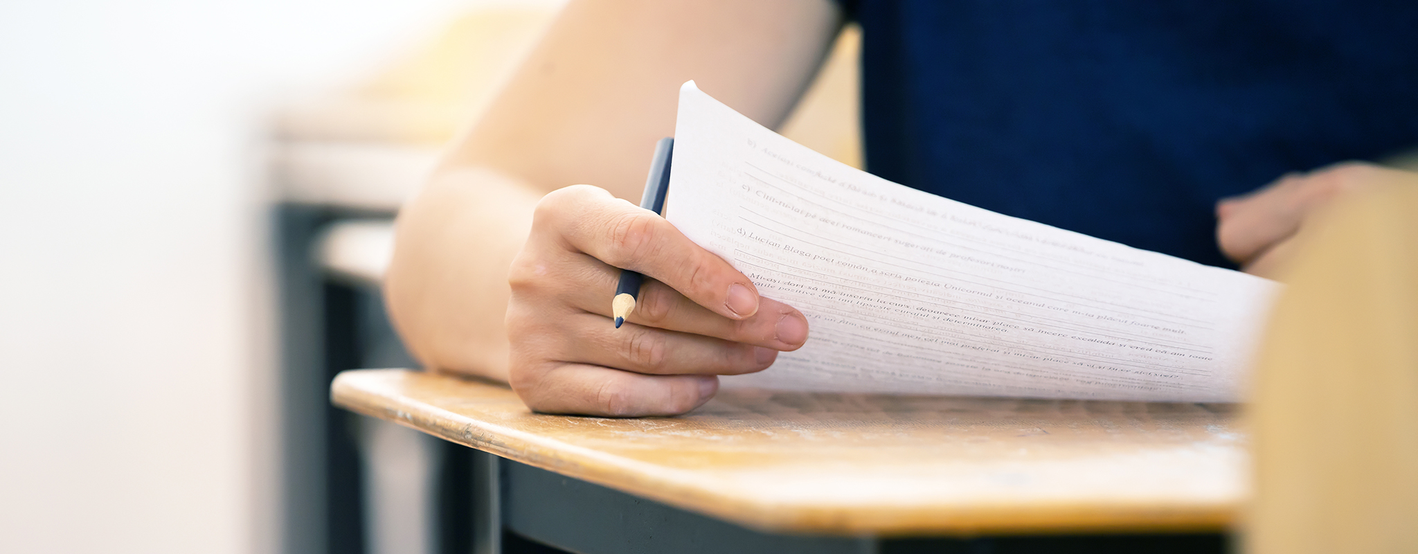 student sitting at a desk taking a test.