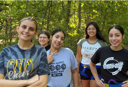 Students smiling while in the woods