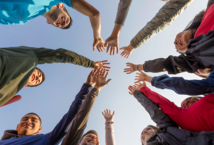 A group of people with their hands in the air