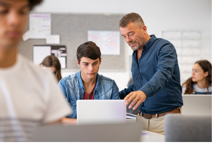 Male teacher with a student in the classroom