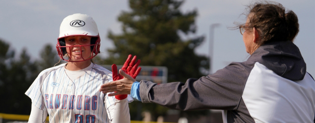 softball player giving the coach a high five.